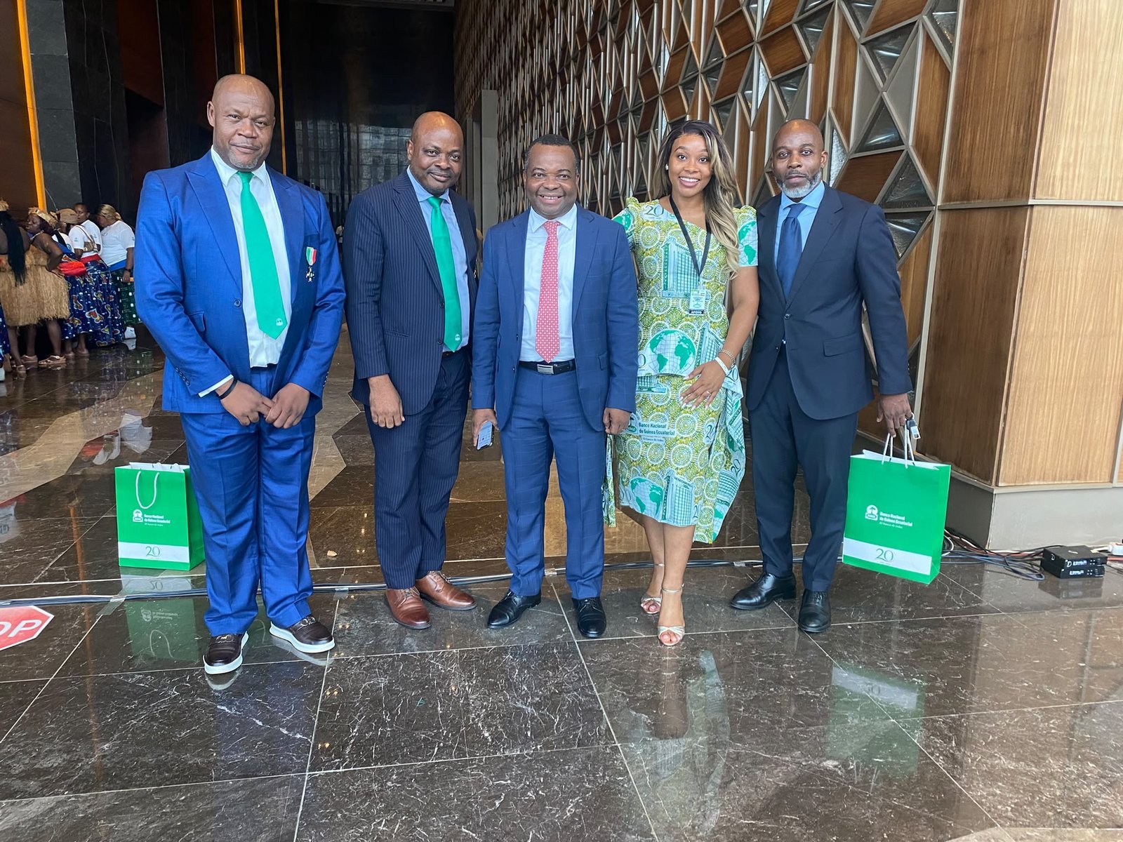 Five attendees pose in the lobby during BANGE's 20th anniversary celebration.